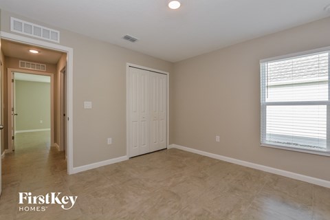 the master bedroom has a large closet and a door to the hallway