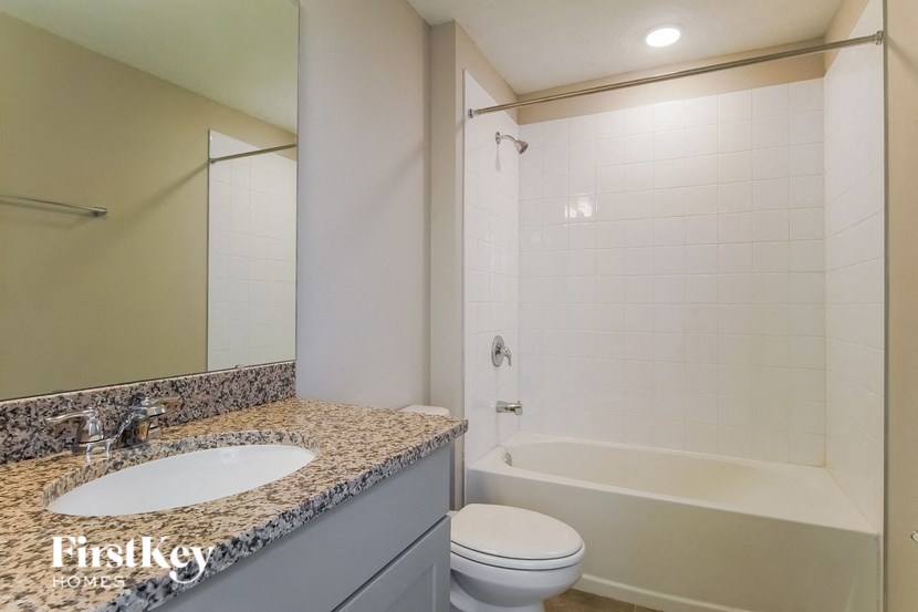 a bathroom with a sink and a shower and a toilet