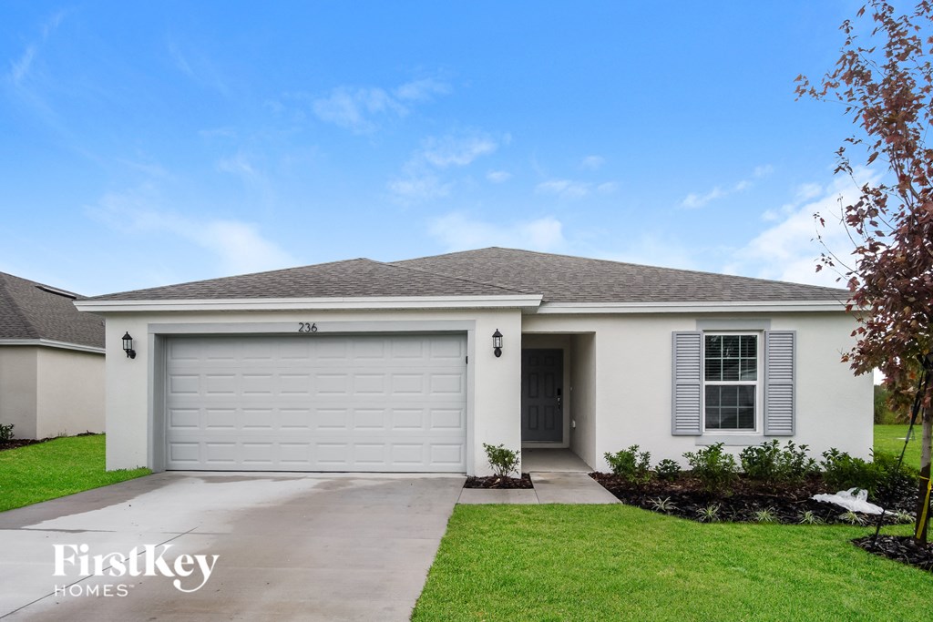 a white house with a driveway and a garage door