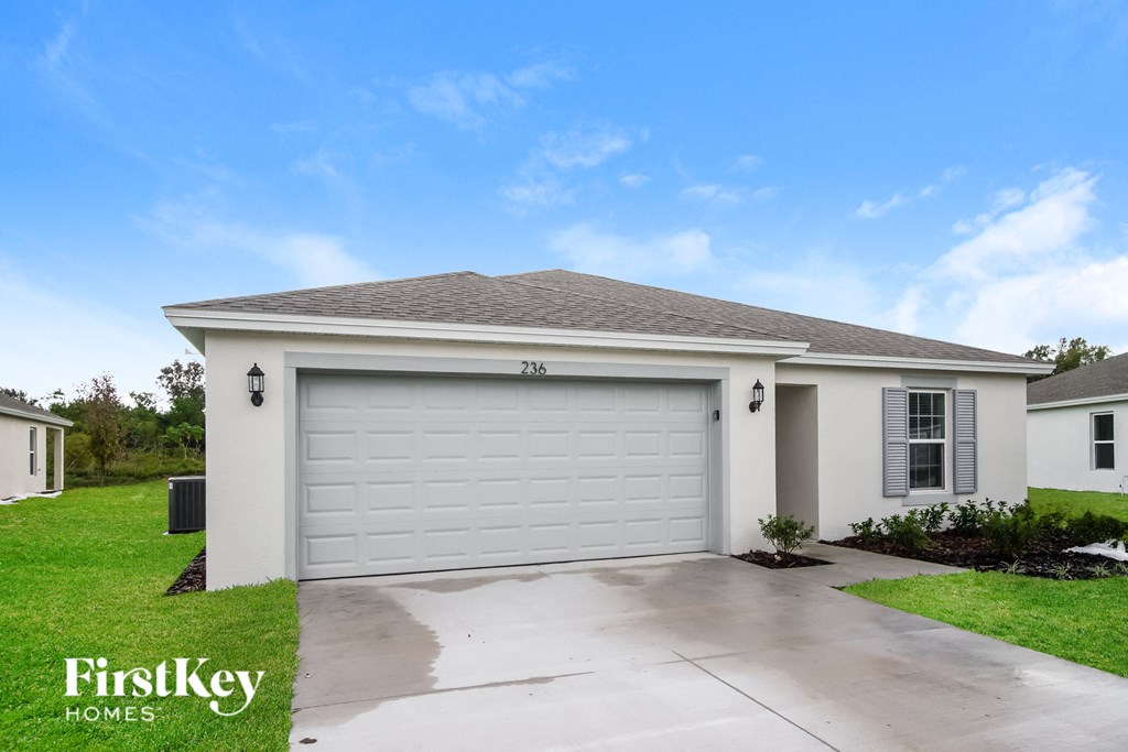 a white house with a white garage door