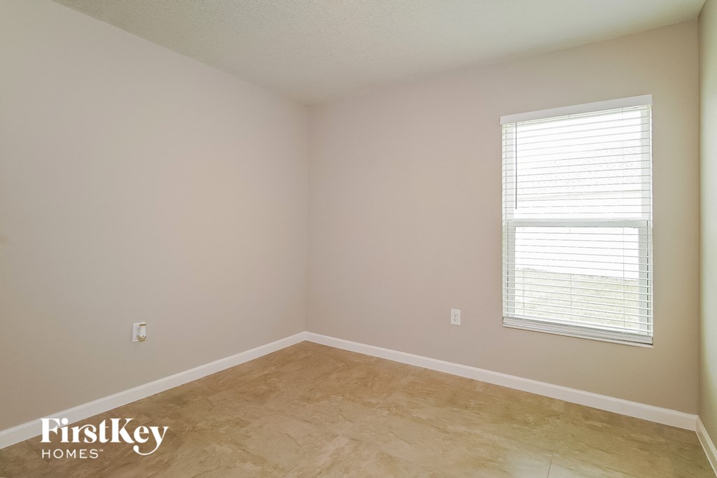 a empty room with a window and a wooden floor