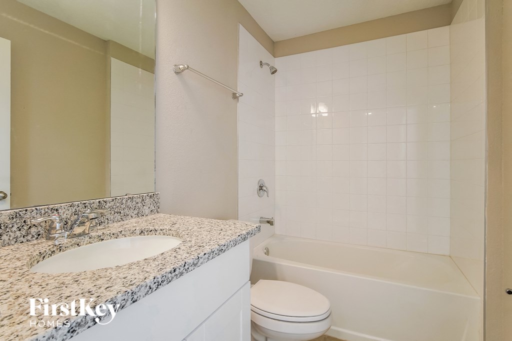 a bathroom with a sink and a toilet and a shower
