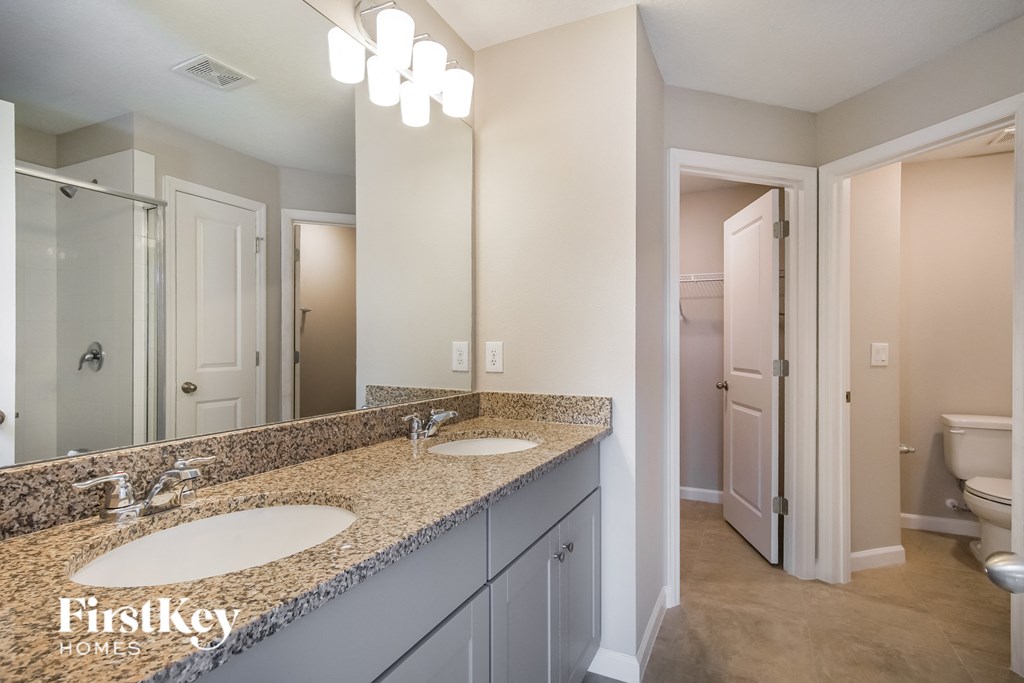 a bathroom with two sinks and a large mirror