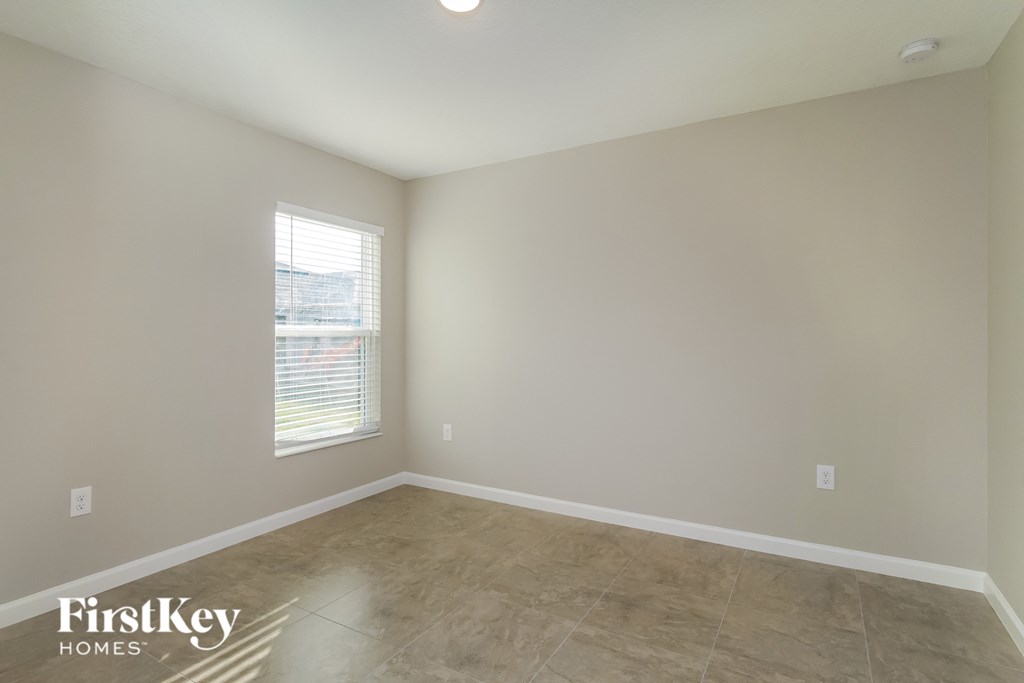 the living room of an empty house with a large window