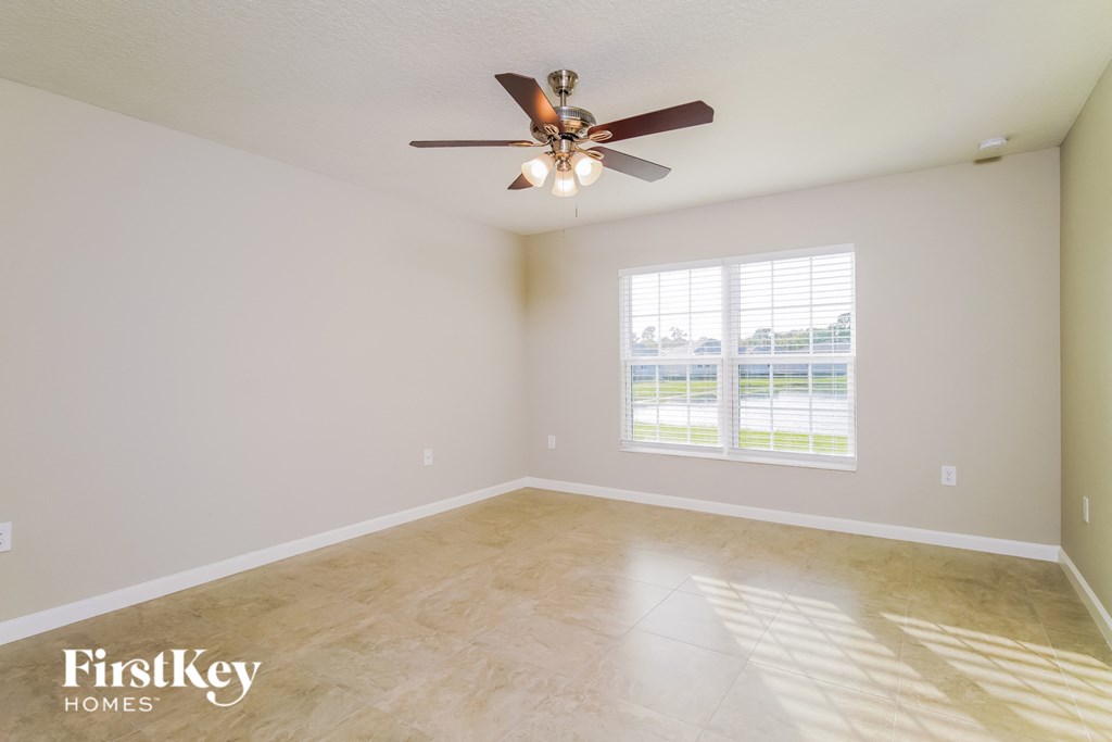 a living room with a ceiling fan and a window