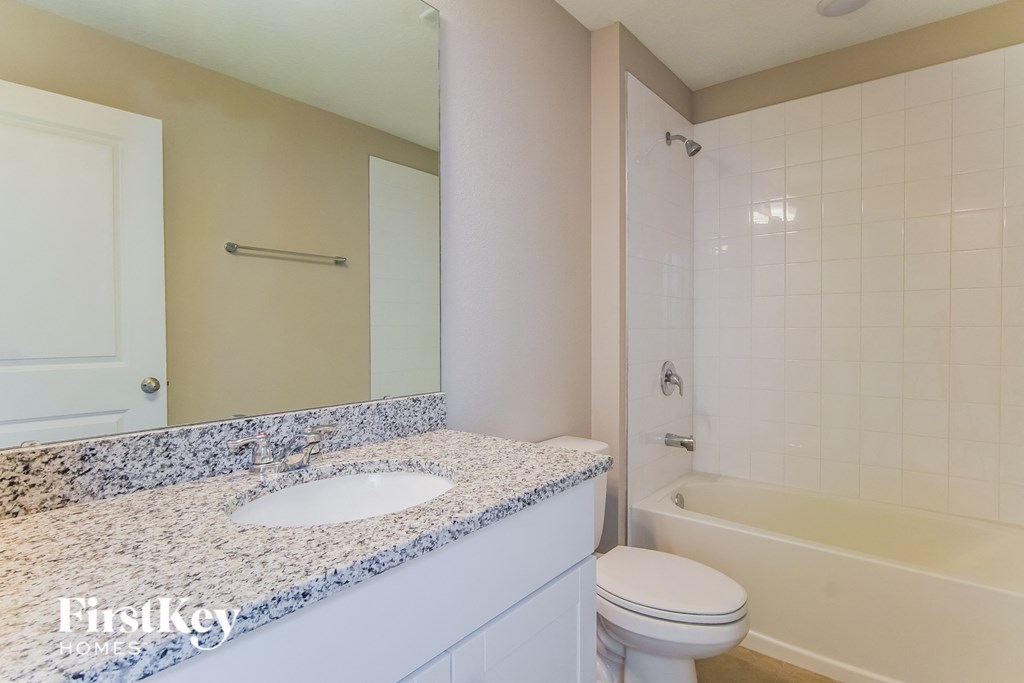 a bathroom with a sink and a tub and a toilet