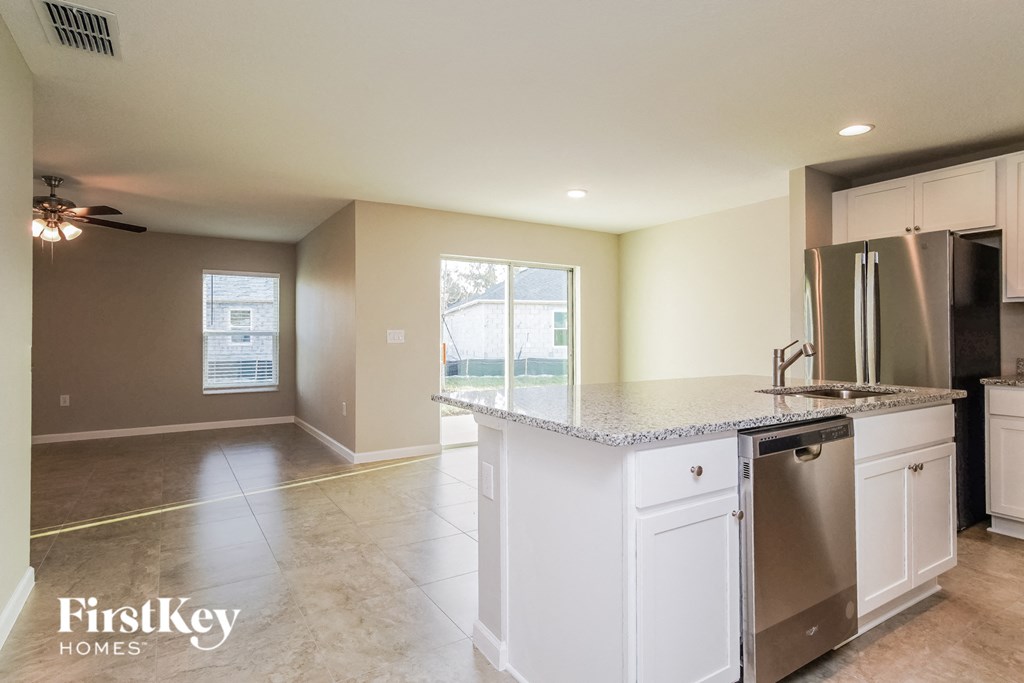 a kitchen with white cabinets and a counter top