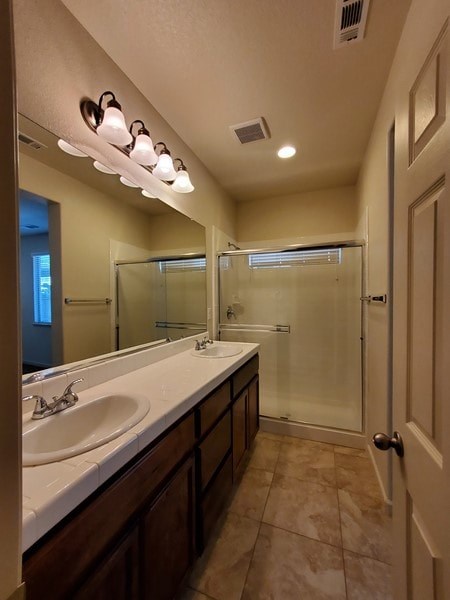 A bathroom with a sink, mirror, and shower.