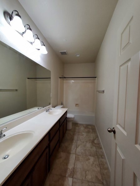 A bathroom with two sinks and a mirror.