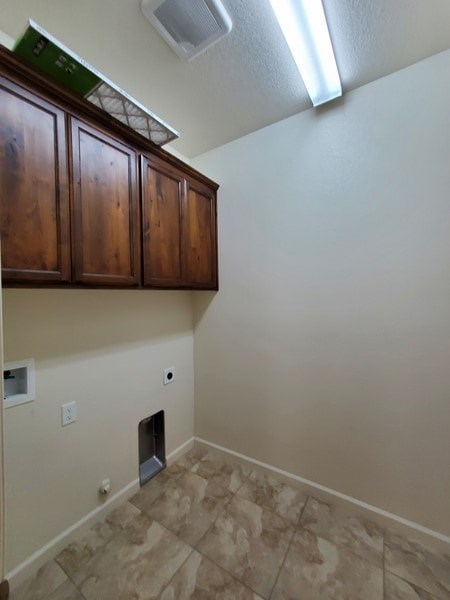 A kitchen with wooden cabinets and a tile floor.