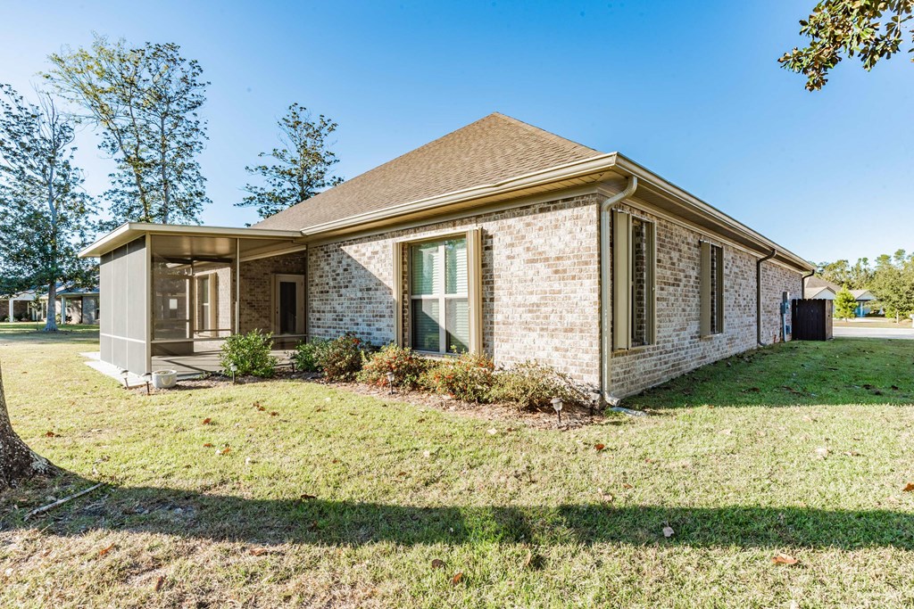 A house with a brown roof and a white brick exterior.
