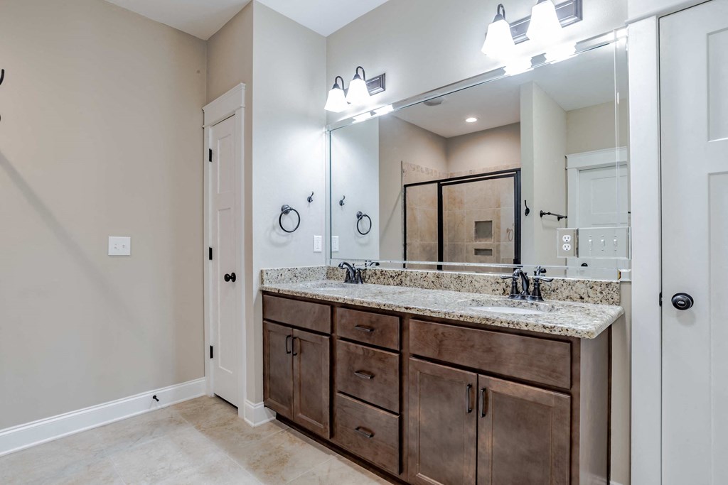 A bathroom with a vanity and a mirror.