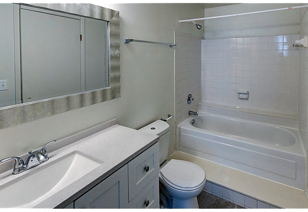 a bathroom with a sink toilet and a tub