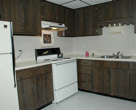 a kitchen with a stove and a sink and a refrigerator