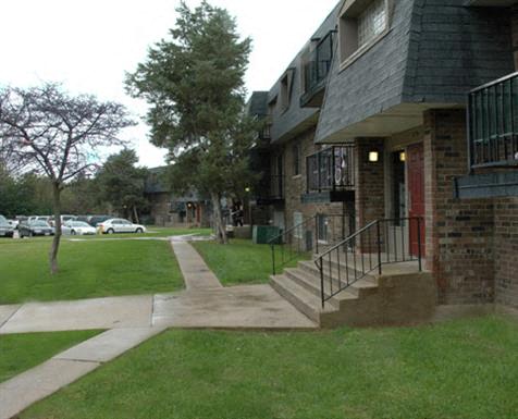 the front of a house with a yard and stairs
