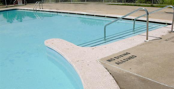 a swimming pool with a diving board in it