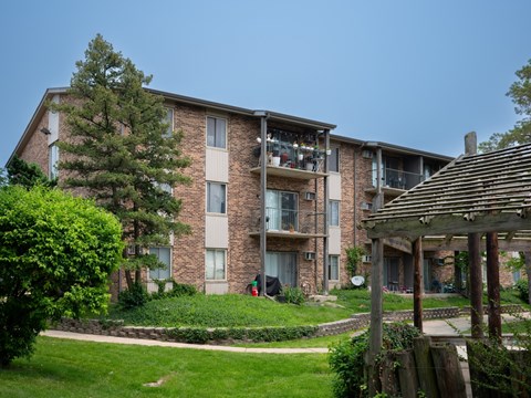 Apartment building with a tree in front of it.