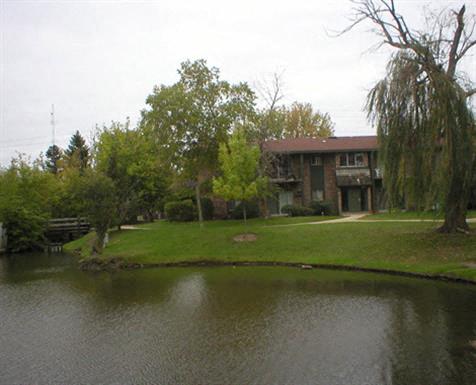 a house with a pond in front of it