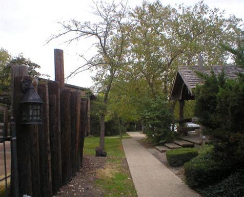a wooden fence with a pathway next to a house