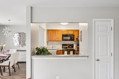 A kitchen with white cabinets and a white countertop.