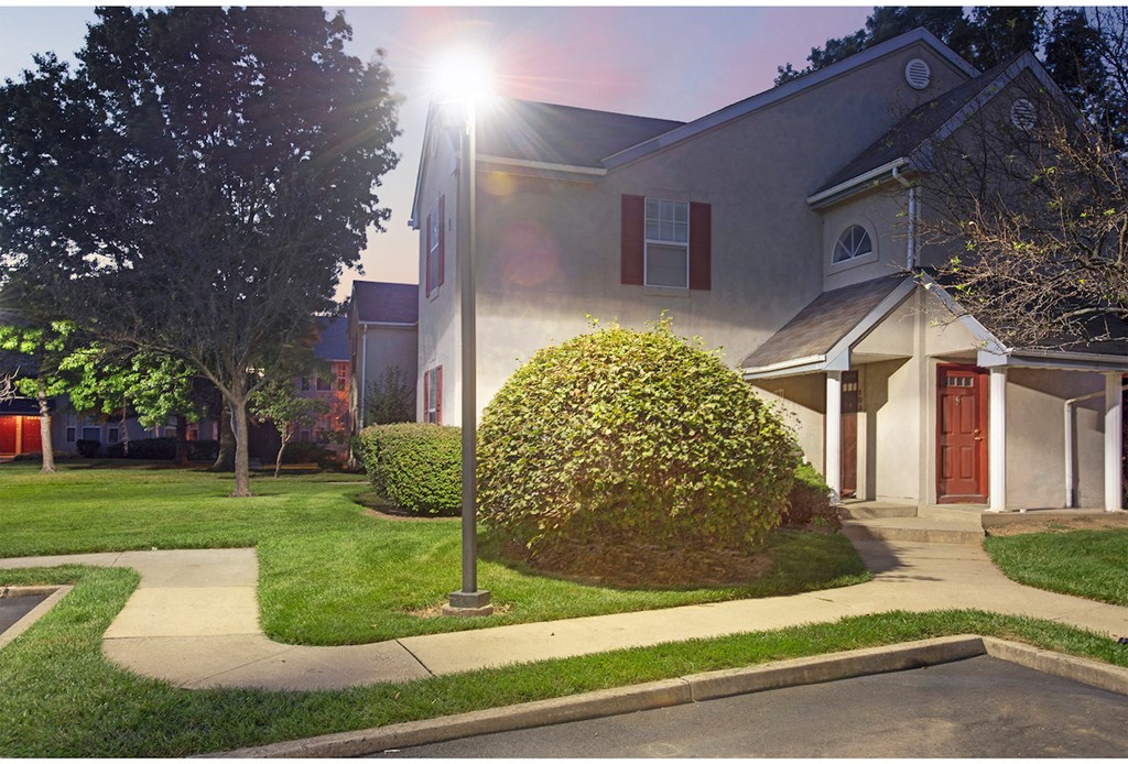 the front of a house with the sun shining on it