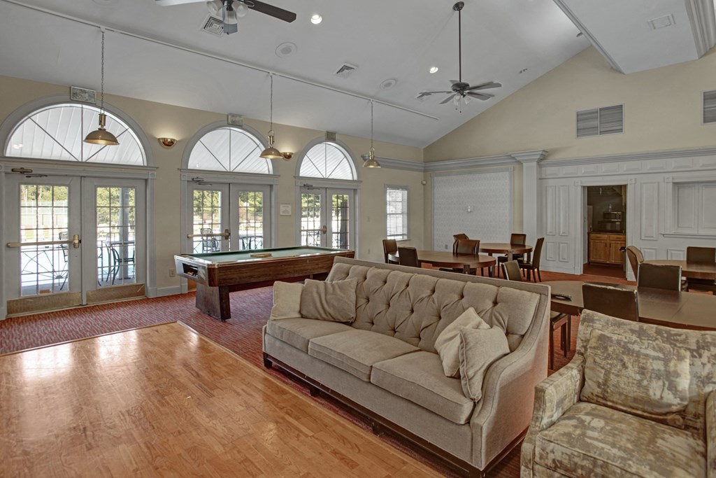 a living room with a couch and a pool table