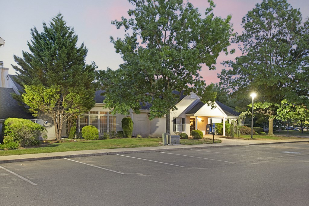 a house with a parking lot and trees