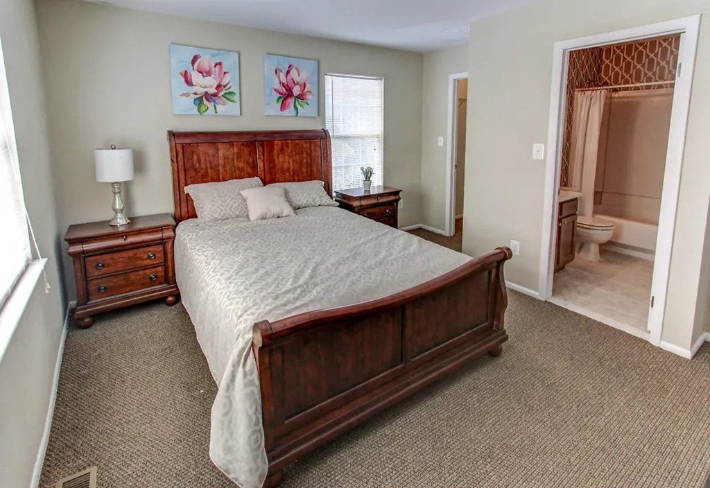 a bedroom with a bed and a bathroom with a shower