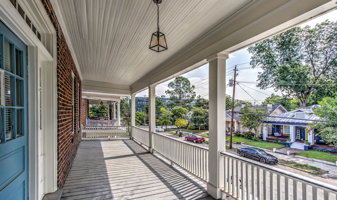 the front porch of a home with a blue door