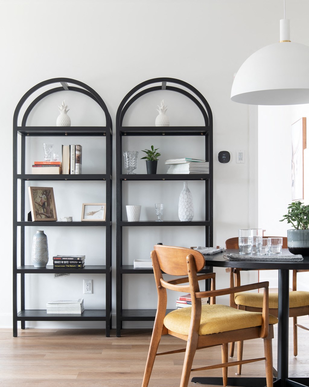 a dining room with a table and chairs and bookshelves