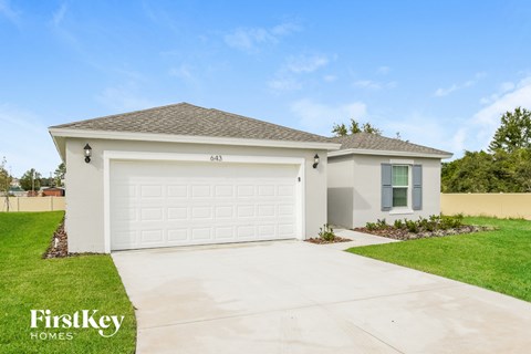 a home with a white garage door and a driveway