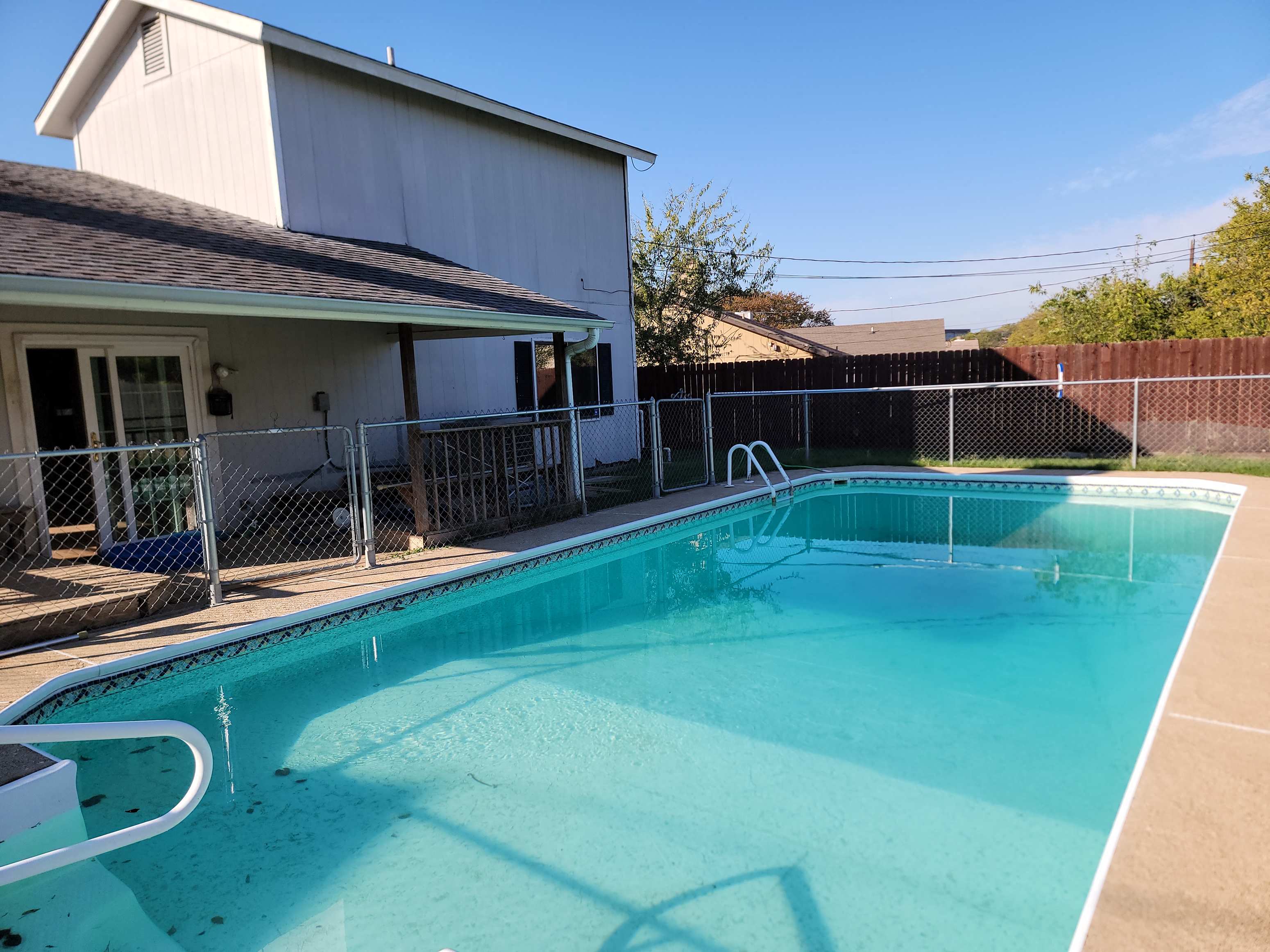a swimming pool in front of a house