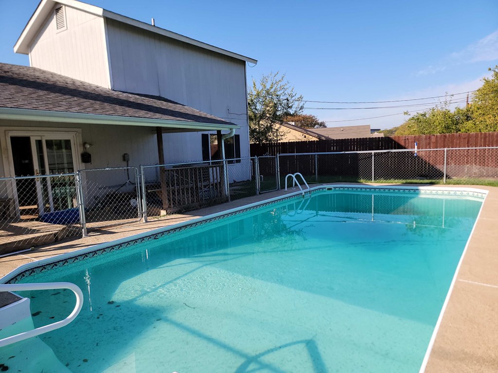 a swimming pool in front of a house