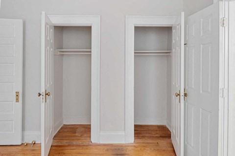 Two white doors open to empty rooms.