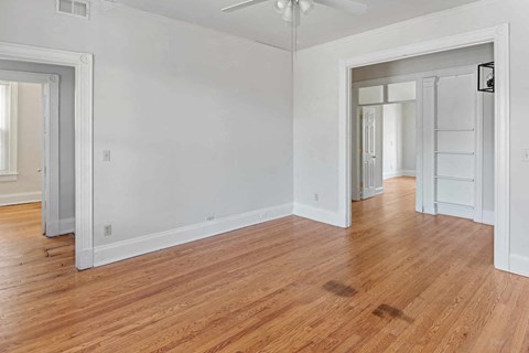 A room with wooden floors and white walls.