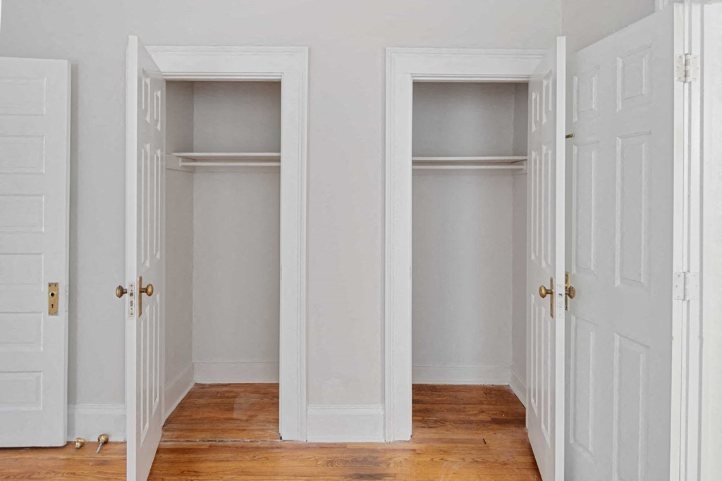 Two white doors open to empty rooms.