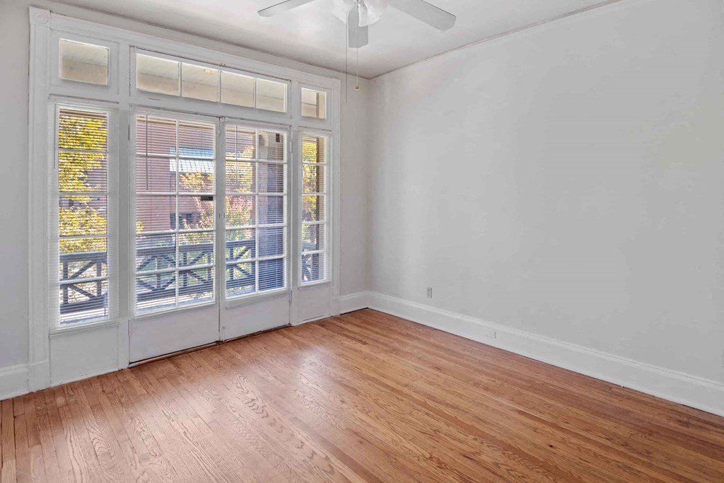A room with a sliding door and a ceiling fan.