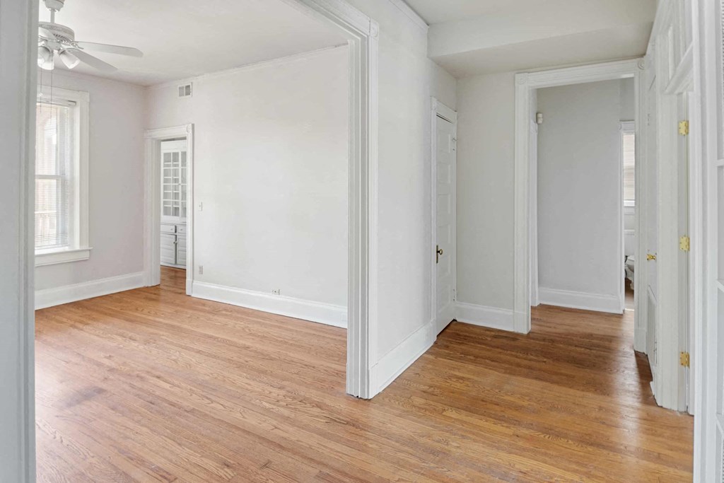 A room with white walls and wooden floors.