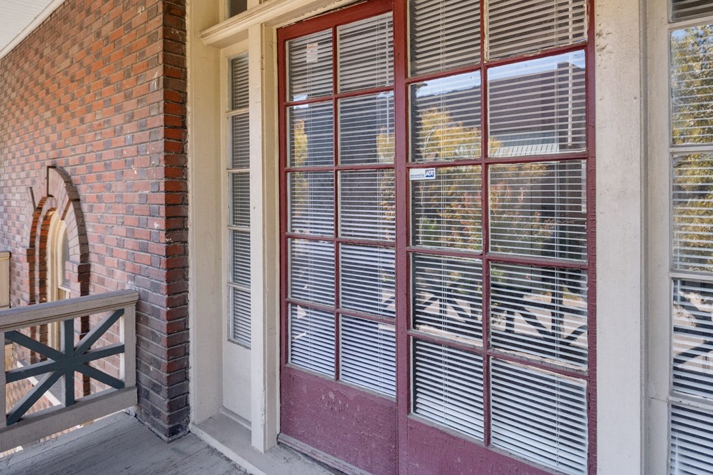 A red door with a window above it.