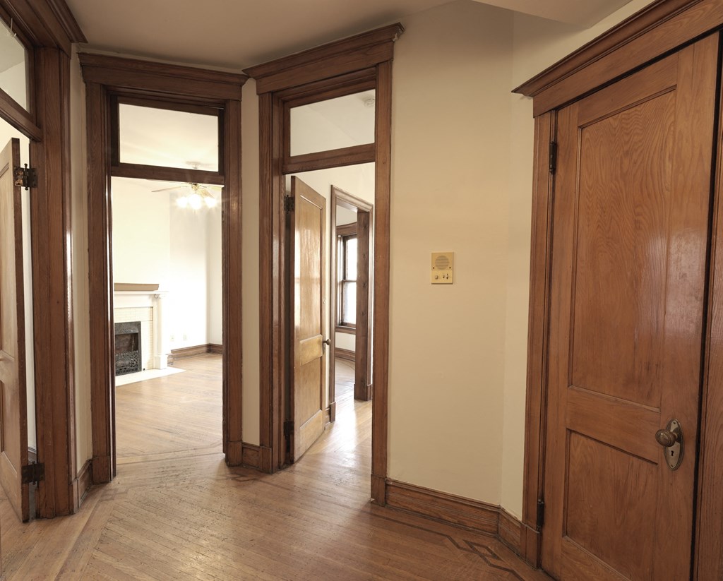 A room with a wooden floor and a wooden door.