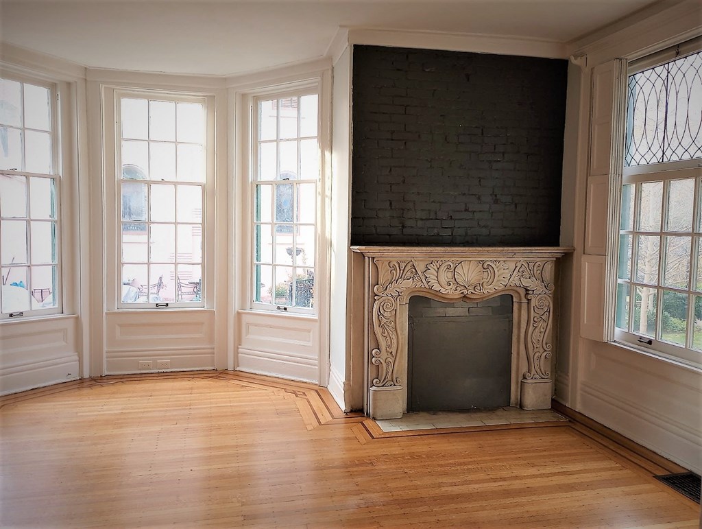 A room with a fireplace and a brick wall.