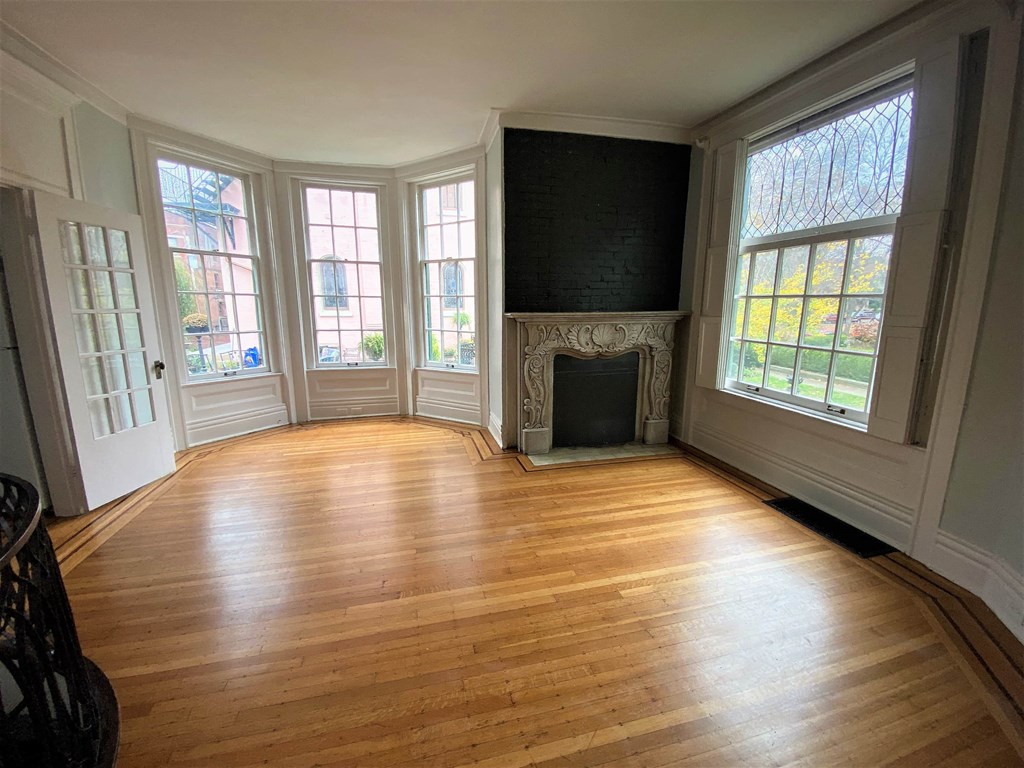A room with a fireplace and a large window.