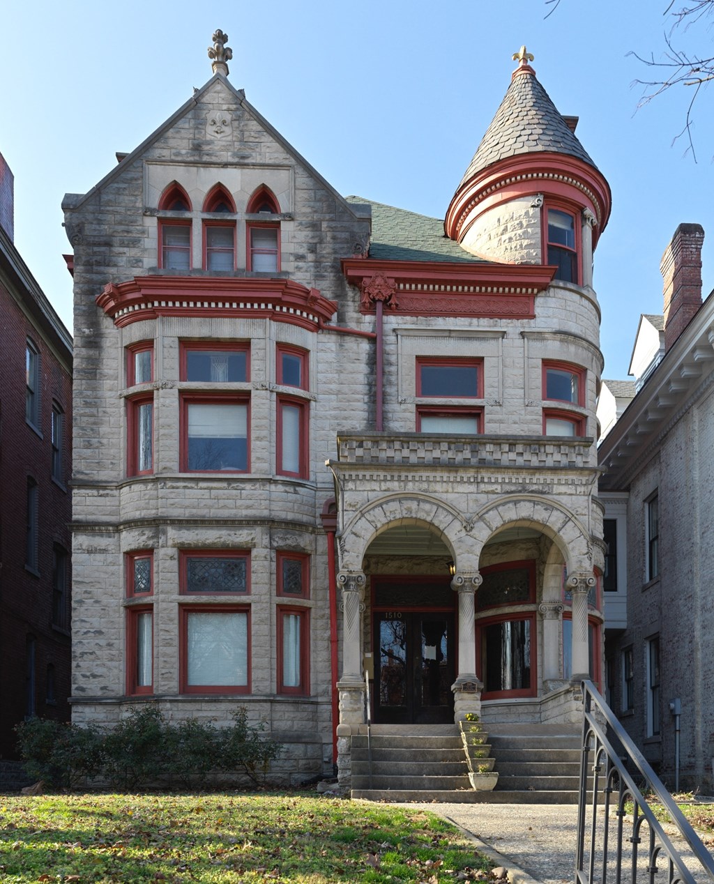 A large, old building with a turret and a cross on top.