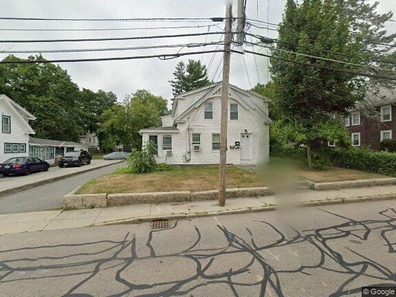 a white house on the corner of a street
