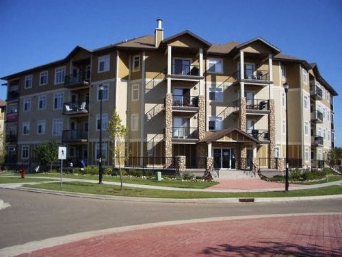 an apartment building on the corner of a street