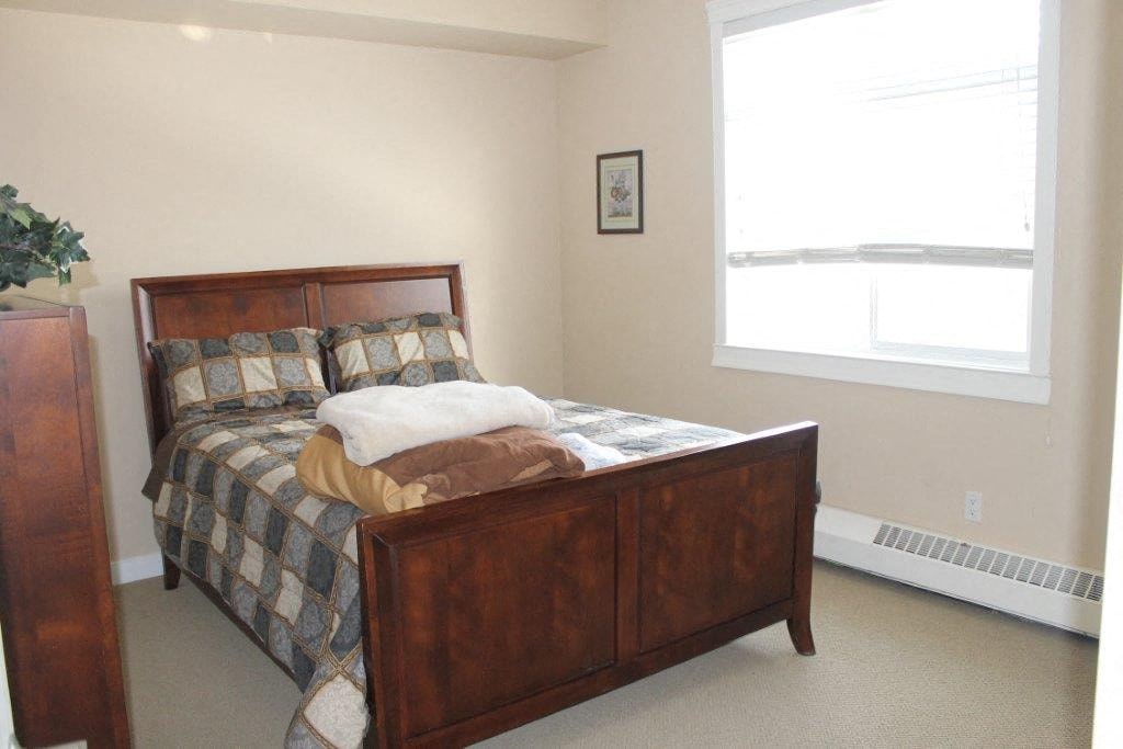 a bedroom with a bed and a window