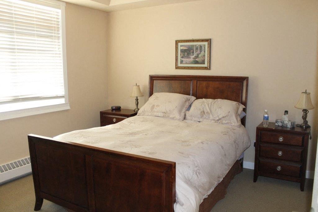 a bedroom with a bed and two night stands