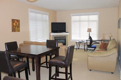 a living room with a table and chairs and a television