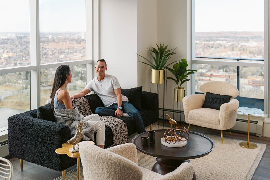 a man and a woman sitting on couches in a living room