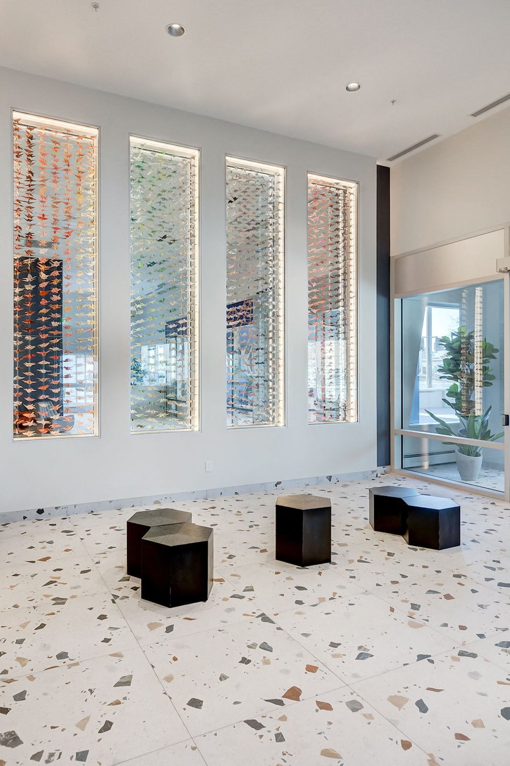 a group of benches in a room with windows